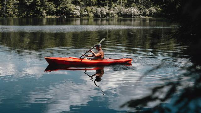 Man on a red sit-on kayak