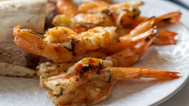 Seven butterflied shrimp cooked on the BBQ and served with a piece of bazlama.